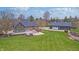 Sprawling backyard with expansive lawn, patio, and accessory building at 6778 Old Hunt Club Rd, Zionsville, IN 46077