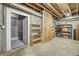 Basement with exposed walls, wooden shelves, utility access and an open, unfinished area at 6778 Old Hunt Club Rd, Zionsville, IN 46077