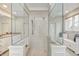 Contemporary bathroom features a glass enclosed shower with a bench near the vanity at 6778 Old Hunt Club Rd, Zionsville, IN 46077