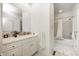 Bathroom with white cabinets, patterned tile accents and a shower-tub with white shower curtain at 6778 Old Hunt Club Rd, Zionsville, IN 46077