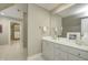 Bathroom featuring white vanity with silver hardware with a doorway view to the closet and tile floors at 6778 Old Hunt Club Rd, Zionsville, IN 46077