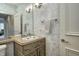 Charming bathroom featuring an ornate vanity with decorative sink and textured wall at 6778 Old Hunt Club Rd, Zionsville, IN 46077