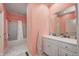 Bathroom featuring pink wallpaper, white cabinets and a shower-tub with white shower curtain at 6778 Old Hunt Club Rd, Zionsville, IN 46077