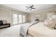 Bright bedroom with plush carpet, patio doors, and stylish decor, offering comfort and relaxation at 6778 Old Hunt Club Rd, Zionsville, IN 46077