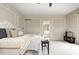 Well-lit bedroom with paneled walls, opening to en-suite bathroom and featuring plush carpet at 6778 Old Hunt Club Rd, Zionsville, IN 46077