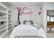 Charming ' bedroom showcases a delightful tree mural and cozy decor, creating a fun and inviting space at 6778 Old Hunt Club Rd, Zionsville, IN 46077
