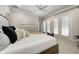 Bright bedroom features shuttered doors, a ceiling fan, and a neutral color palette that create a serene and inviting atmosphere at 6778 Old Hunt Club Rd, Zionsville, IN 46077
