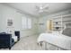 Bright bedroom featuring a comfortable chair, white shuttered window, and ensuite bathroom access at 6778 Old Hunt Club Rd, Zionsville, IN 46077