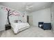 Cozy ' bedroom features an accent wall with whimsical tree art and a comfy chair in a light-filled space at 6778 Old Hunt Club Rd, Zionsville, IN 46077