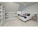 Bright bedroom features a built-in bookshelf and window seat with bright natural light and neutral color scheme at 6778 Old Hunt Club Rd, Zionsville, IN 46077