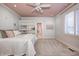 Charming bedroom with a pink ceiling, built-in shelves and en-suite bathroom access at 6778 Old Hunt Club Rd, Zionsville, IN 46077