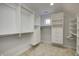 Walk-in closet with custom built-in shelving and drawers provides ample storage and organization options at 6778 Old Hunt Club Rd, Zionsville, IN 46077