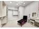 Well-organized walk-in closet with ample shelving, vanity and comfortable chair offering a practical storage solution at 6778 Old Hunt Club Rd, Zionsville, IN 46077