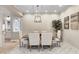 Traditional dining room featuring decorative tiled floor and a modern farmhouse chandelier lighting a wood dining table at 6778 Old Hunt Club Rd, Zionsville, IN 46077