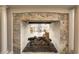 Stone fireplace with view to sunroom at 6778 Old Hunt Club Rd, Zionsville, IN 46077
