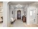 Elegant foyer with hardwood floors, a decorative rug, and a detailed wooden door at 6778 Old Hunt Club Rd, Zionsville, IN 46077