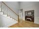 Foyer featuring hardwood floors, staircase, and a piano with bench in an adjacent nook at 6778 Old Hunt Club Rd, Zionsville, IN 46077