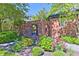 Lush gardens with a brick archway and colorful flowerbeds at 6778 Old Hunt Club Rd, Zionsville, IN 46077