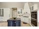 Kitchen featuring custom cabinets, stainless appliances and a large center island with granite counter tops at 6778 Old Hunt Club Rd, Zionsville, IN 46077