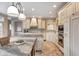 Spacious eat-in kitchen featuring granite countertops, custom cabinets, and stainless steel appliances at 6778 Old Hunt Club Rd, Zionsville, IN 46077