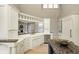 Kitchen with custom cabinets, a peninsula with sink, stainless steel appliances and granite countertops at 6778 Old Hunt Club Rd, Zionsville, IN 46077