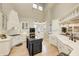 Open kitchen with white cabinets, stainless appliances, a large island and high ceilings with natural light at 6778 Old Hunt Club Rd, Zionsville, IN 46077