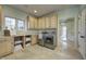 Well-organized laundry room with cabinets, countertops, modern appliances, and travertine flooring at 6778 Old Hunt Club Rd, Zionsville, IN 46077