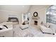Cozy living room featuring a stone fireplace, neutral decor, and hardwood floors at 6778 Old Hunt Club Rd, Zionsville, IN 46077