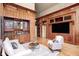 Stylish living room with wood paneling, wet bar, and comfortable seating at 6778 Old Hunt Club Rd, Zionsville, IN 46077
