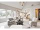 Open living area with large windows and kitchen in background at 6778 Old Hunt Club Rd, Zionsville, IN 46077
