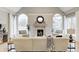 Inviting living room with a stone fireplace, arched windows, and stylish furniture at 6778 Old Hunt Club Rd, Zionsville, IN 46077