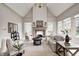 Open-concept living room with fireplace features vaulted ceilings and is filled with natural light at 6778 Old Hunt Club Rd, Zionsville, IN 46077