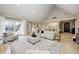 Open-concept living room with hardwood floors, large windows, and access to dining area at 6778 Old Hunt Club Rd, Zionsville, IN 46077