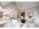 Bright living room with fireplace, large windows, and comfortable seating at 6778 Old Hunt Club Rd, Zionsville, IN 46077