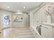 Sun-filled mudroom with storage bench seating and easy access to the home's exterior at 6778 Old Hunt Club Rd, Zionsville, IN 46077