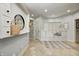 Bright mudroom with built-in storage, tiled floor, and access to other areas of the house at 6778 Old Hunt Club Rd, Zionsville, IN 46077