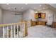 Cozy office area with custom wood cabinets located on a second floor landing with stairs and white railing at 6778 Old Hunt Club Rd, Zionsville, IN 46077