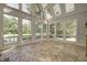 Sunroom with many windows offering plentiful light and scenic backyard views at 6778 Old Hunt Club Rd, Zionsville, IN 46077