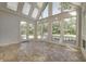 Sunroom with many windows and tile floors provides scenic views of the backyard at 6778 Old Hunt Club Rd, Zionsville, IN 46077