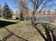 Private backyard view with pond, offering a peaceful and picturesque setting at 7156 Long Shore Cir, Indianapolis, IN 46217