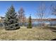 Enjoy the serene backyard view with mature trees and a glimpse of the tranquil pond, offering a peaceful retreat at 7156 Long Shore Cir, Indianapolis, IN 46217