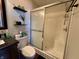 Bathroom featuring a shower, neutral decor, and convenient storage shelves at 7156 Long Shore Cir, Indianapolis, IN 46217