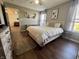 Bright bedroom featuring a comfortable bed, wood floors, and natural light at 7156 Long Shore Cir, Indianapolis, IN 46217