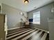 Cozy bedroom featuring a dedicated workspace, built-in shelves, and stylish striped flooring at 7156 Long Shore Cir, Indianapolis, IN 46217