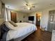 Inviting bedroom with a comfortable bed, ceiling fan, and wood-look flooring at 7156 Long Shore Cir, Indianapolis, IN 46217