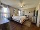 Comfortable bedroom with ceiling fan, natural light, and wood-look flooring at 7156 Long Shore Cir, Indianapolis, IN 46217