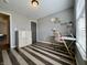 Bright bedroom featuring a dedicated workspace with modern desk, storage, and stylish striped flooring at 7156 Long Shore Cir, Indianapolis, IN 46217