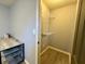 Walk-in closet with wire shelving for optimal storage, adjacent to a room with neutral walls and desk at 7156 Long Shore Cir, Indianapolis, IN 46217