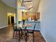 View of the dining area featuring hard wood floors and an adjacent kitchen with stainless steel appliances at 7156 Long Shore Cir, Indianapolis, IN 46217