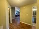 Wide hallway that opens up to the living and dining area, with wood floors throughout the home at 7156 Long Shore Cir, Indianapolis, IN 46217
